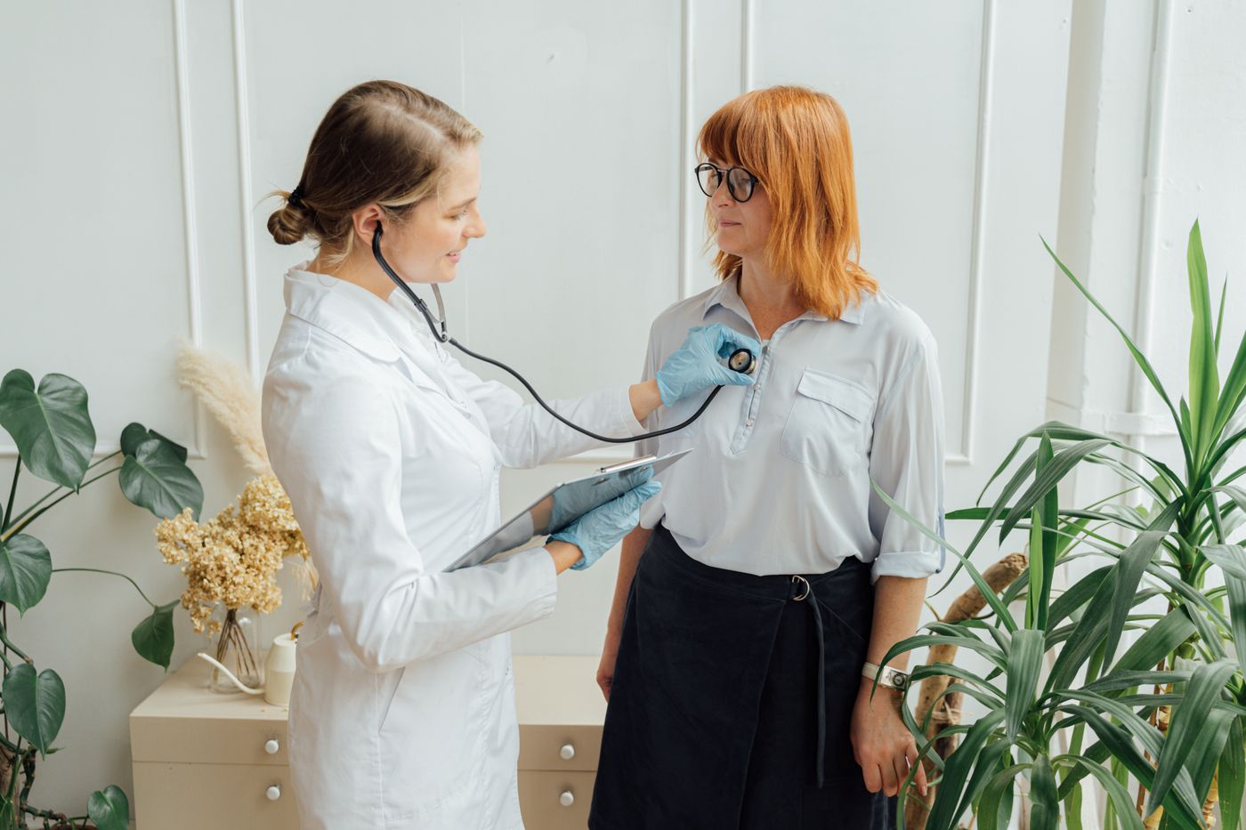A physician listening to a patient with a stethoscope
